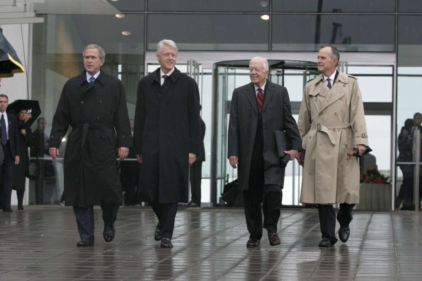 Presidents Bush, Clinton, Carter, Bush senior walking out of the Clinton Center