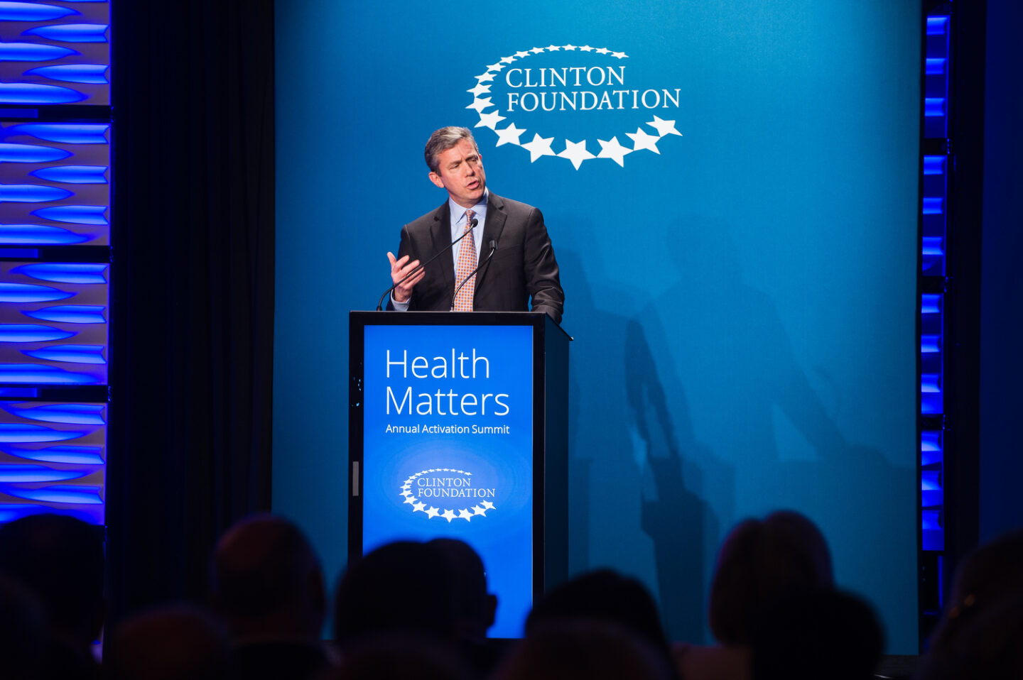 An individual speaks onstage behind a podium that says "Health Matters"