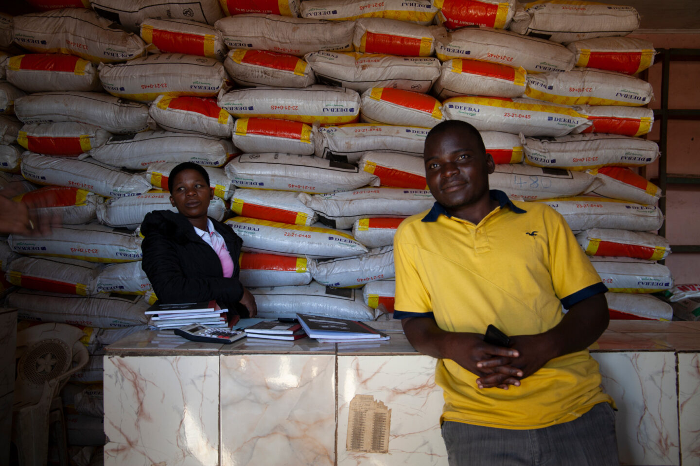Business owners stand in their shop in Malawi
