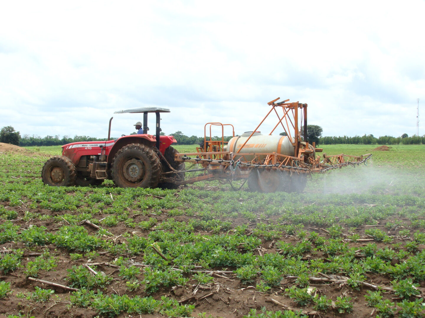 A tractor irrigating a field in Malawi