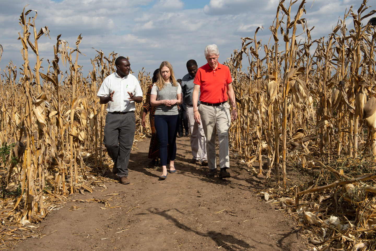 President Clinton and Chelsea Clinton walk around a farm in Malawi