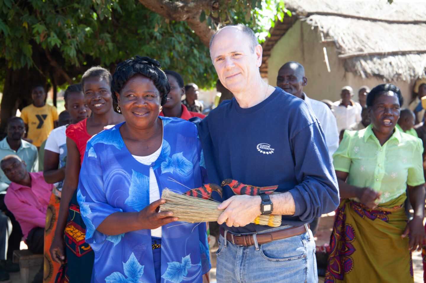A Clinton Foundation staff member meets a farmer in Malawi
