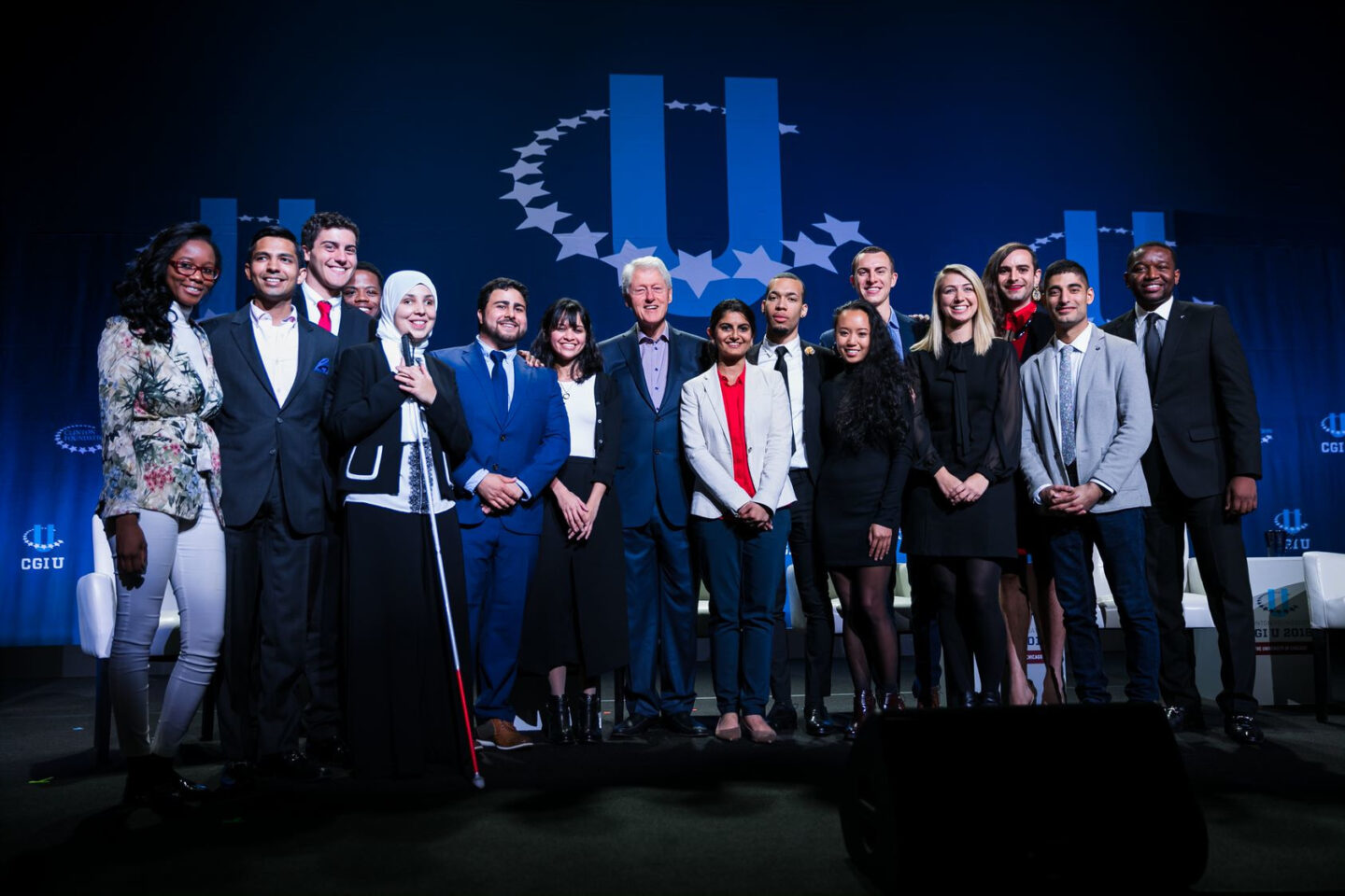 President Clinton takes a photo with students on stage