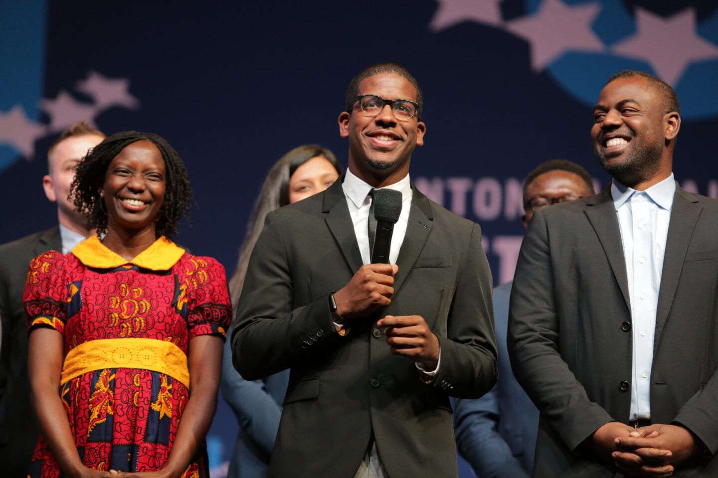 Sixto Cancel and other students speak on stage