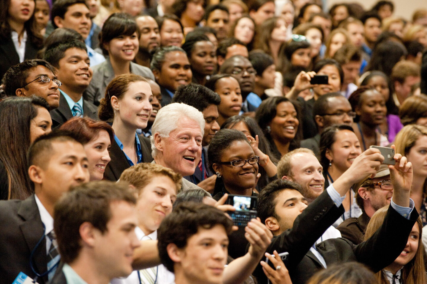 President Clinton takes a photo with students