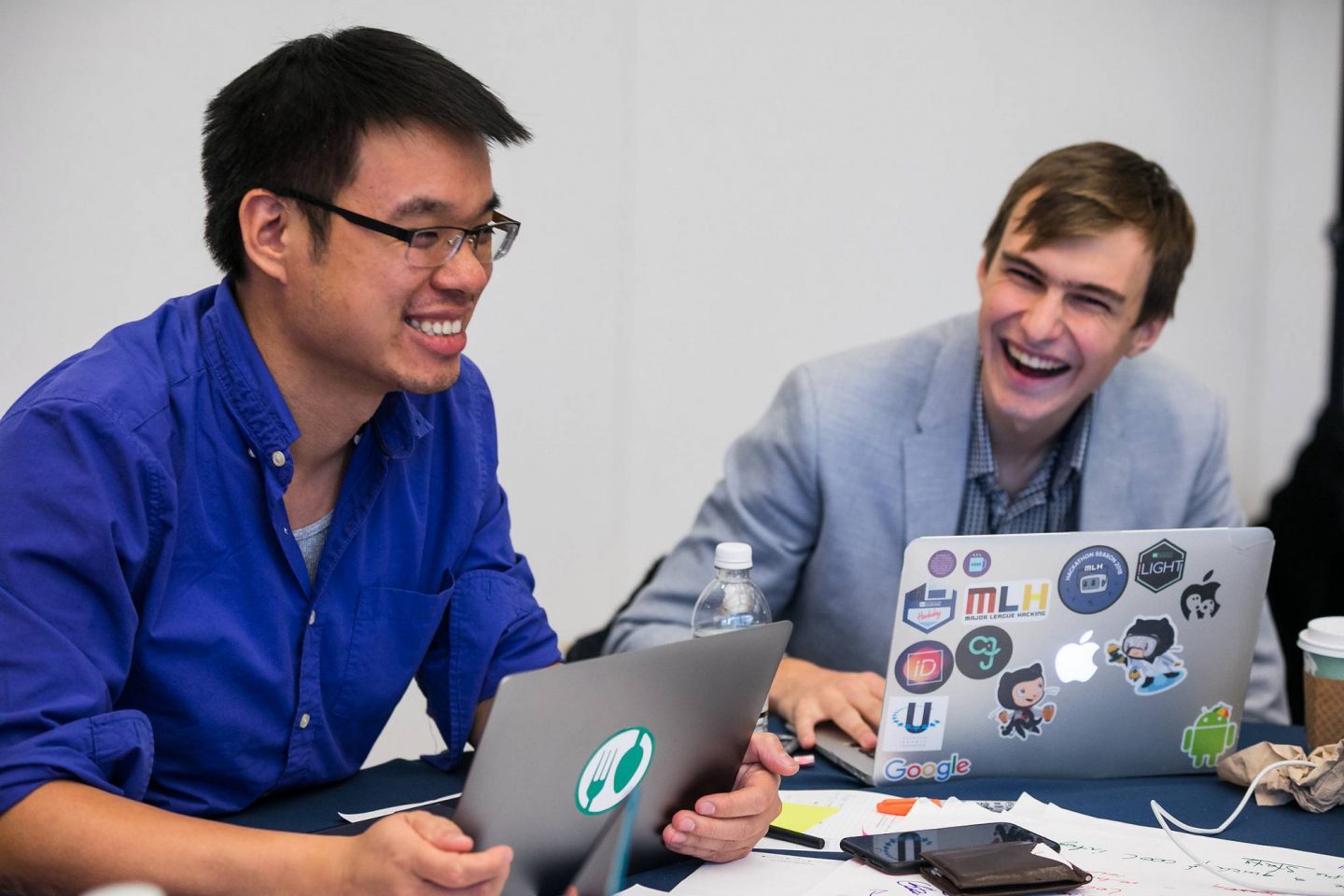 Two individuals with laptops
