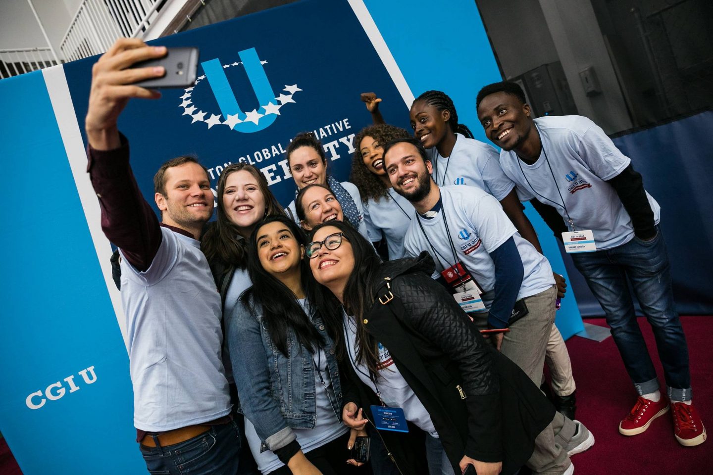 A group of students take a selfie together during a CGI U event