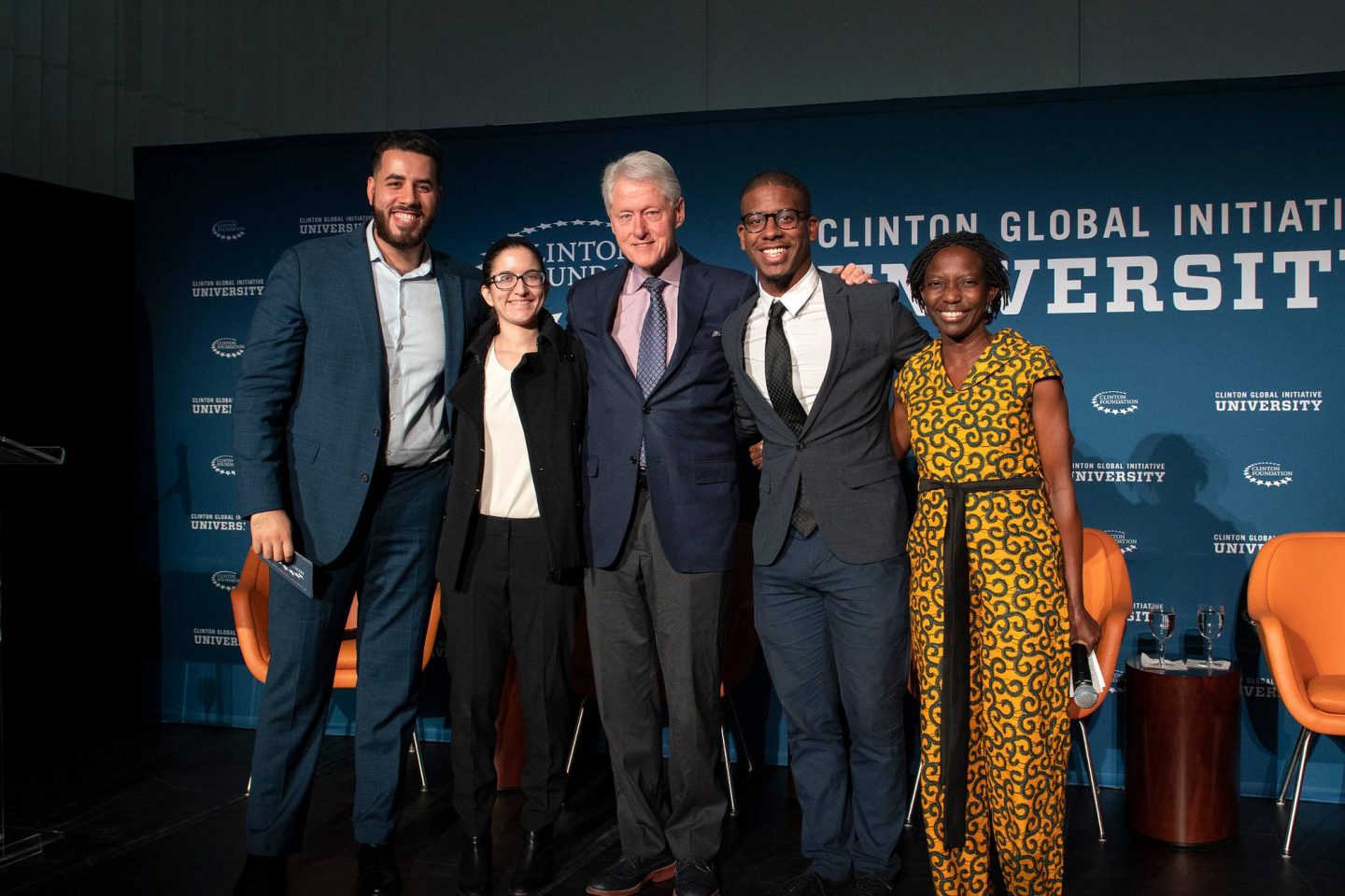 A group of students onstage with President Clinton during a CGI U event