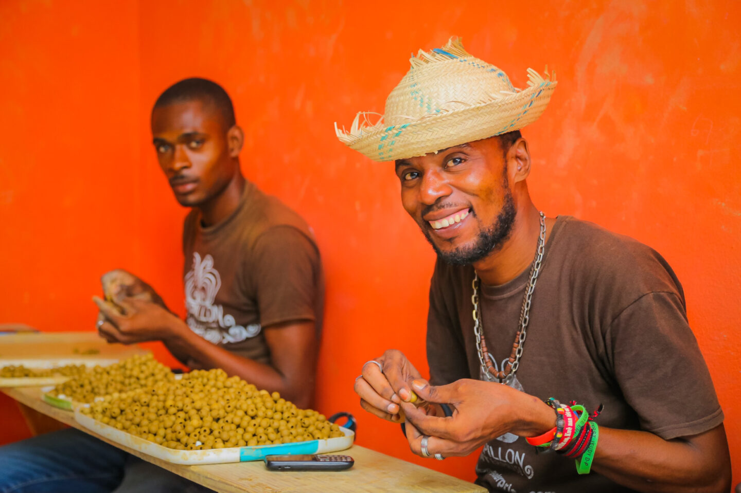 An artisan assembles beads in Haiti