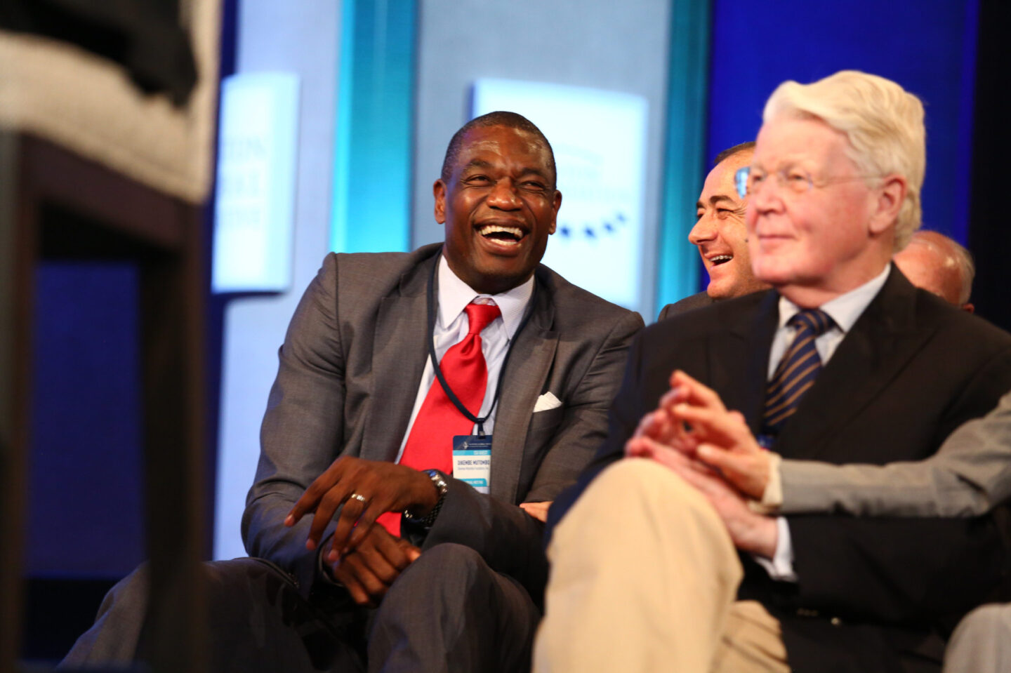 Dikembe Mutombo laughs during a plenary session