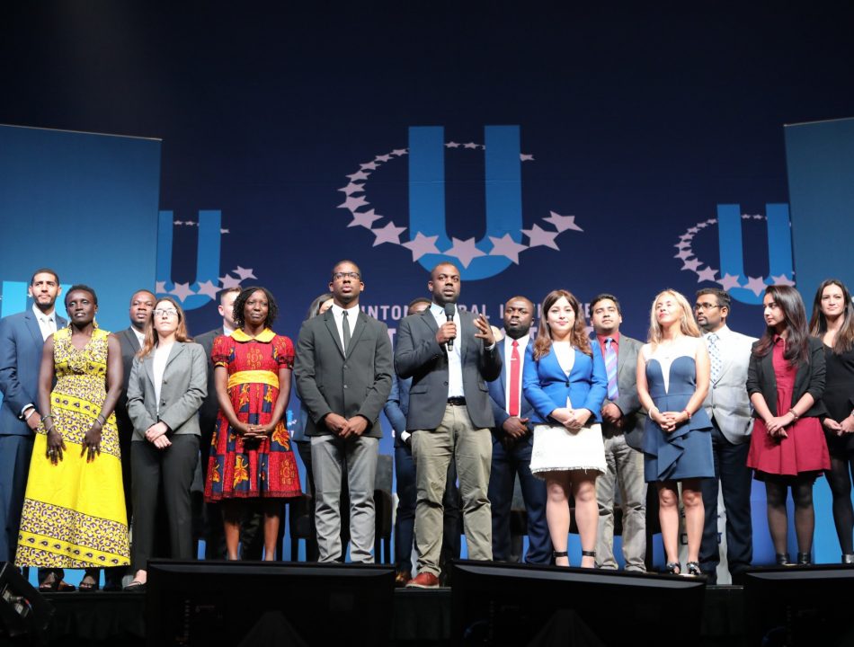 A group of CGI U students stands onstage during a CGI U event