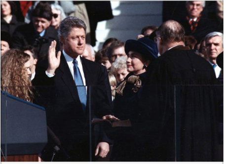 President Clinton raises his right hand and takes the oath of office in front of the United States Capitol in Washington, D.C