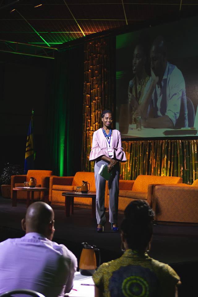 Davina Layne stands onstage during a presentation