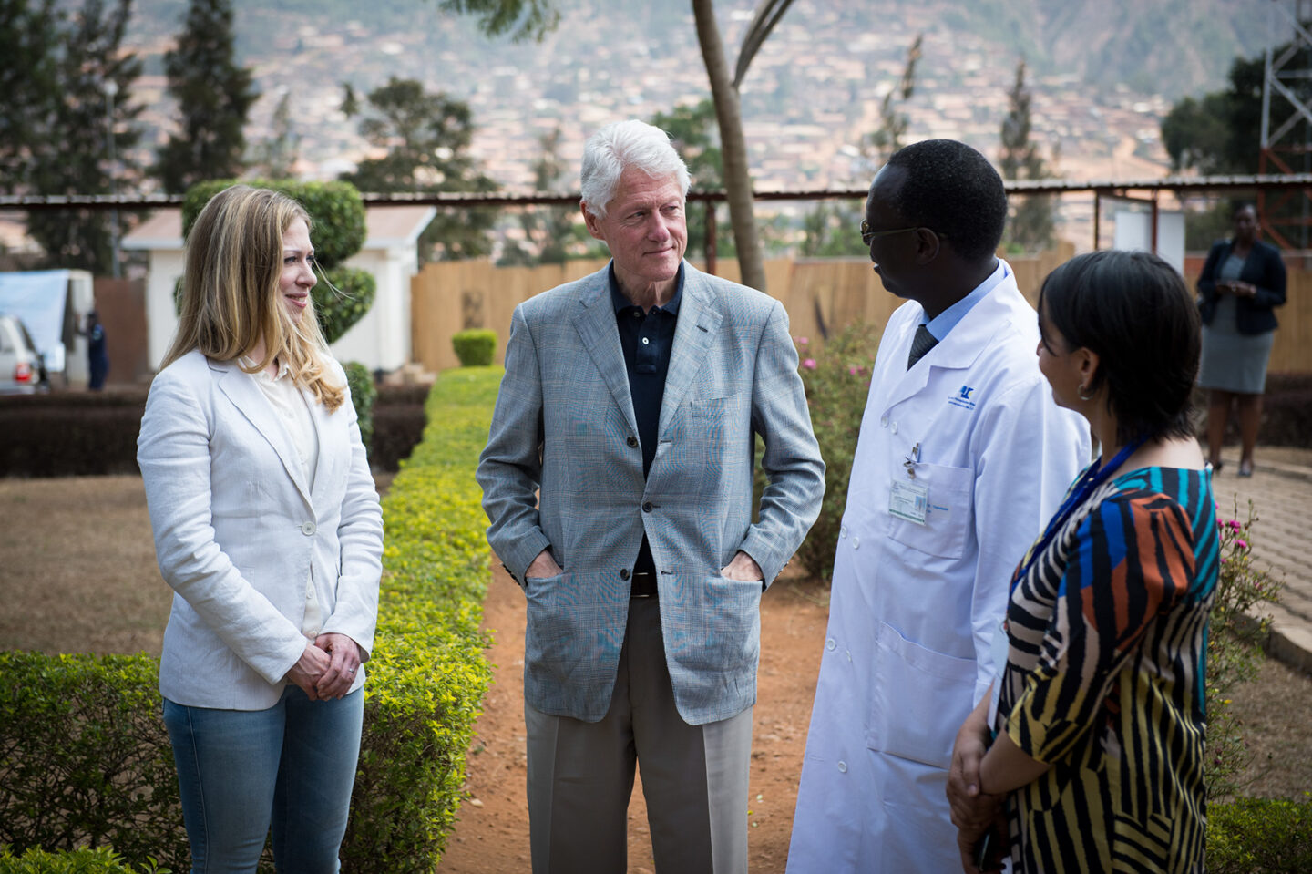 President Clinton and Chelsea Clinton speak with staff at a hospital in Kigali, Rwanda