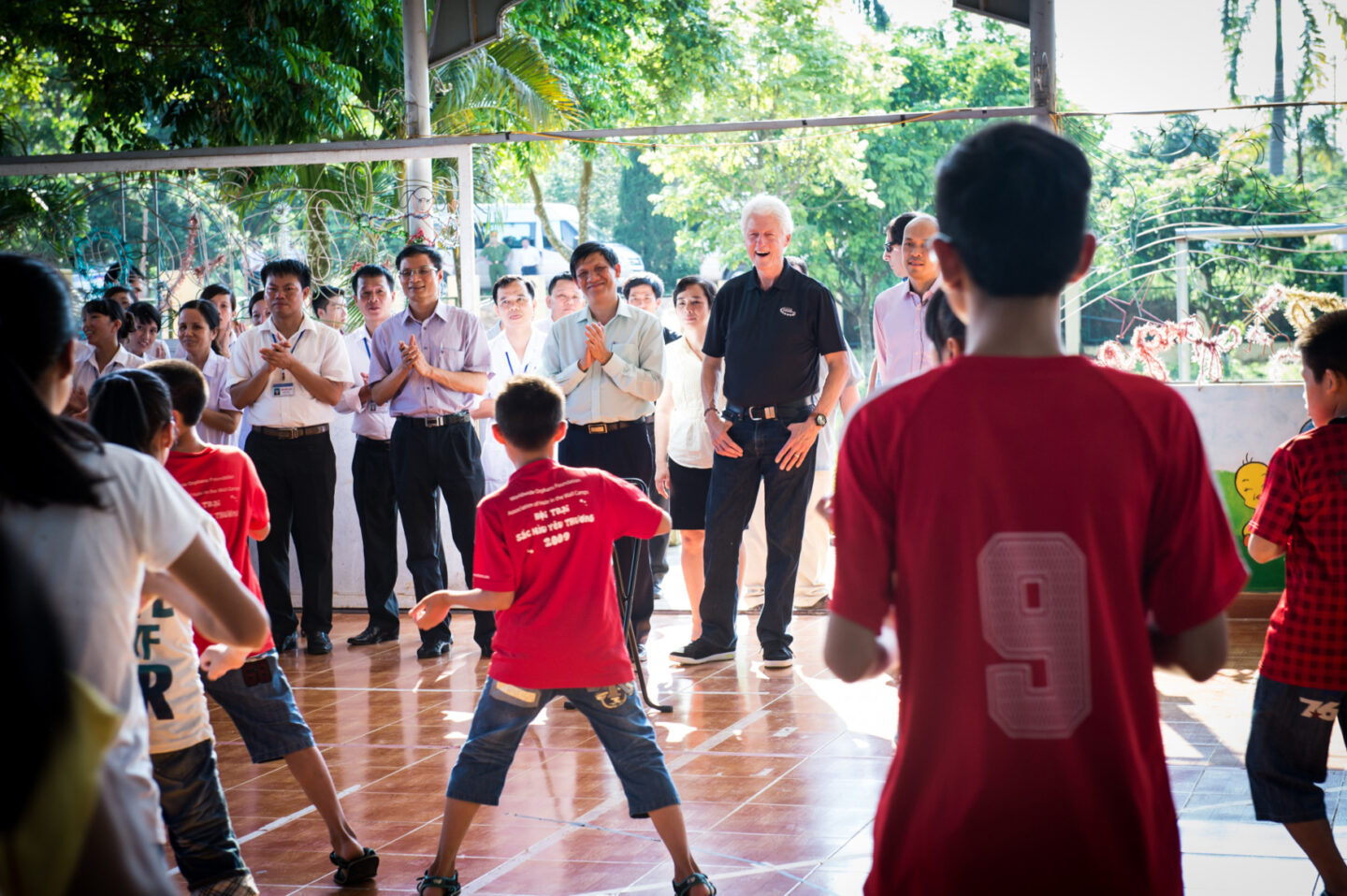 President Clinton and a group of individuals gather at an orphanage in Hanoi, Vietnam
