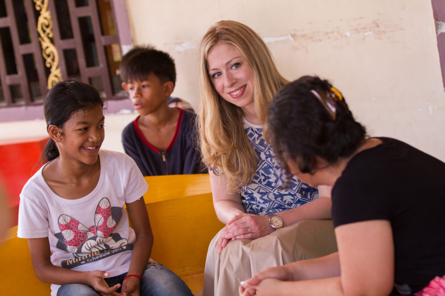 Chelsea Clinton speaks with several individuals at an orphanage in Cambodia