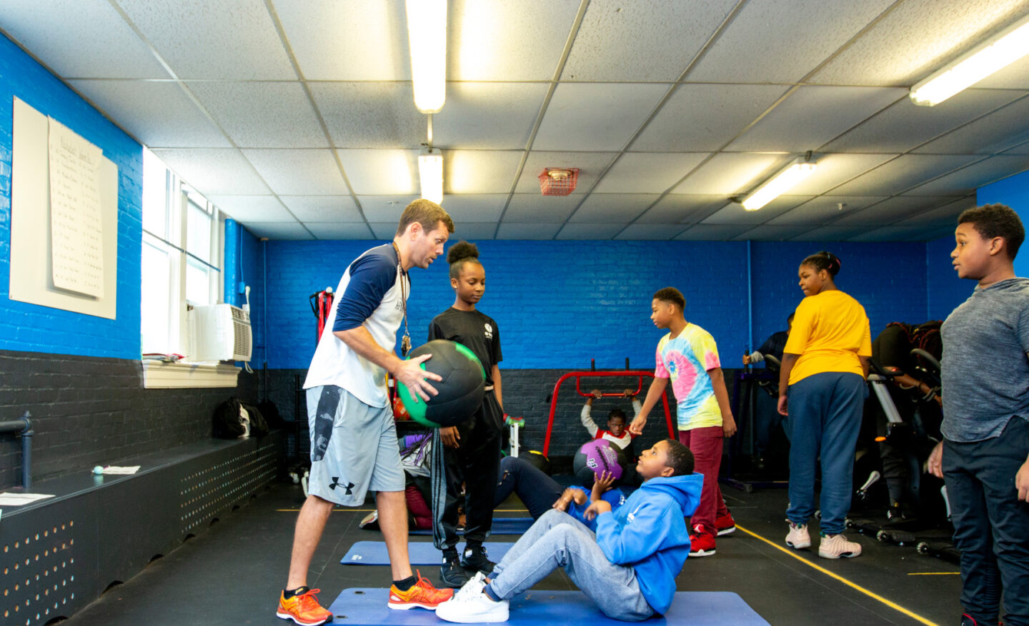 A P.E. teacher teaches a gym class