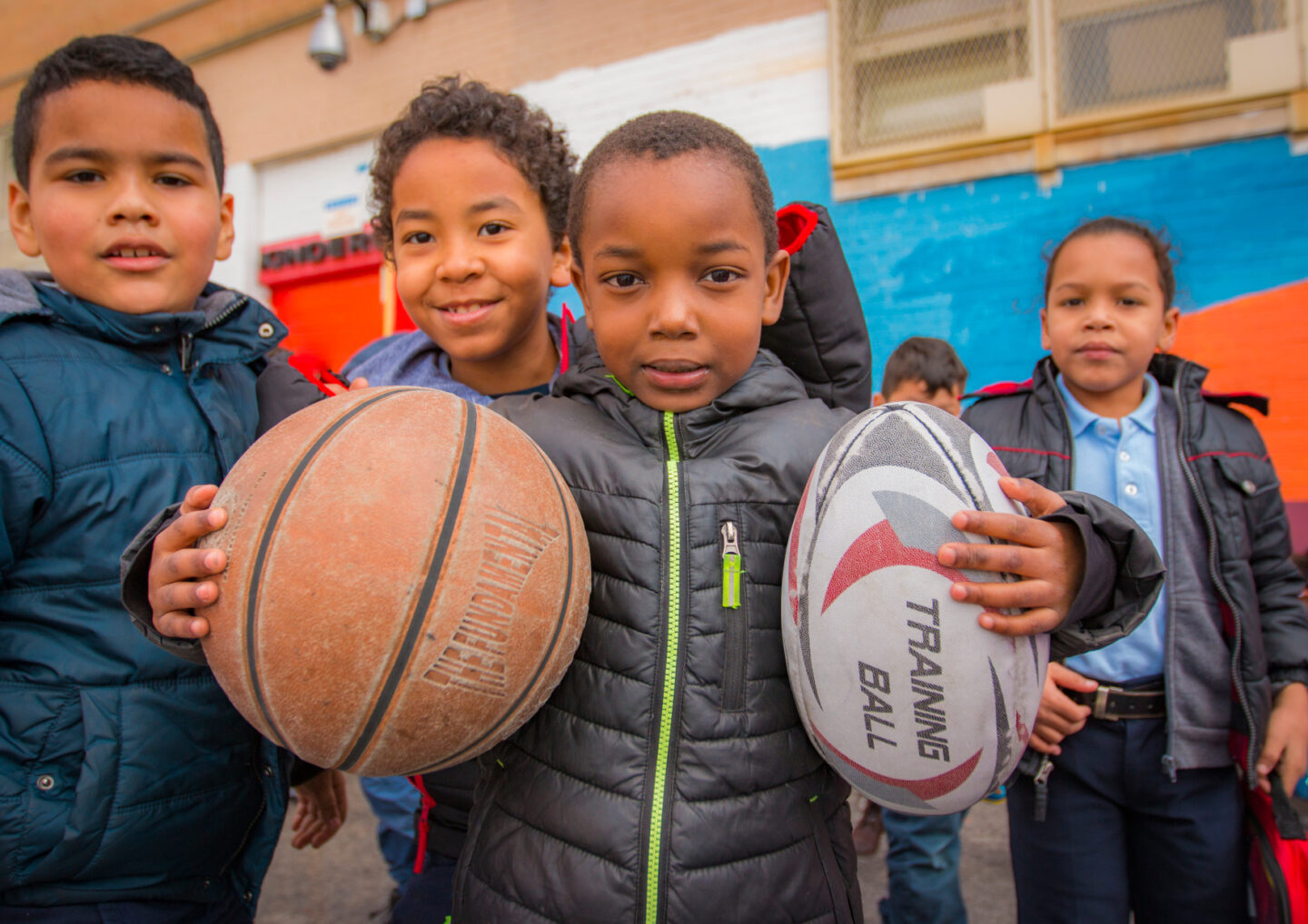 Children playing with sports equipment in New York City