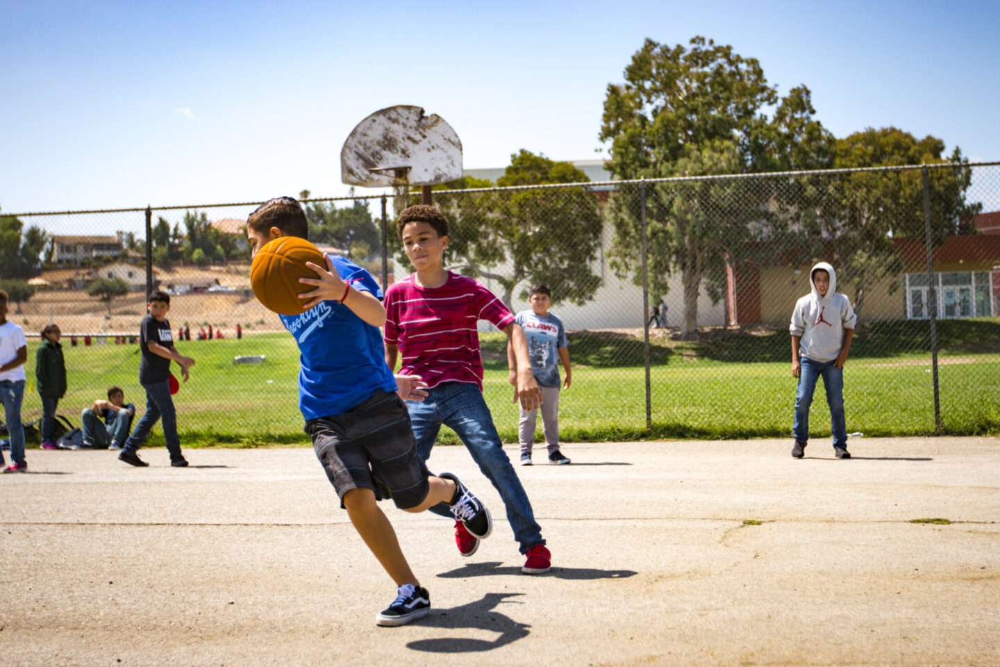 Students playing basketball at a school in California