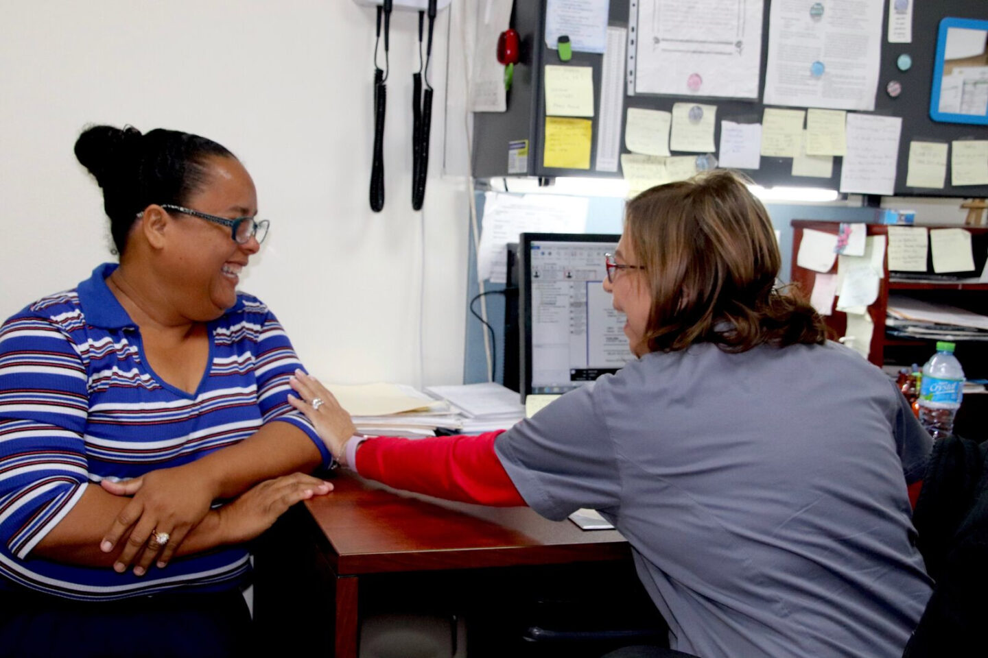 A nurse speaks with a patient at a medical clinic in Puerto Rico