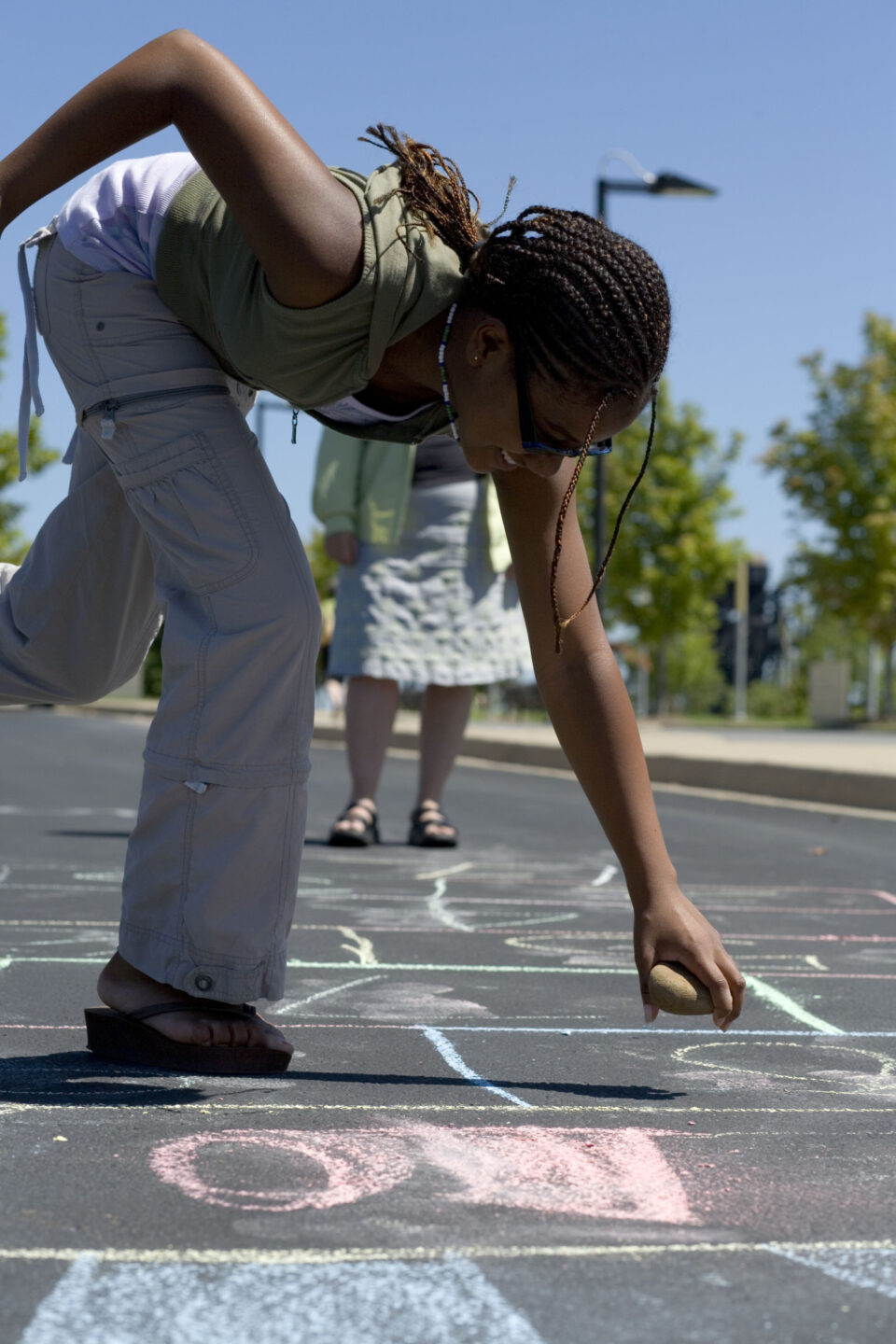 A student plays hopscotch at school