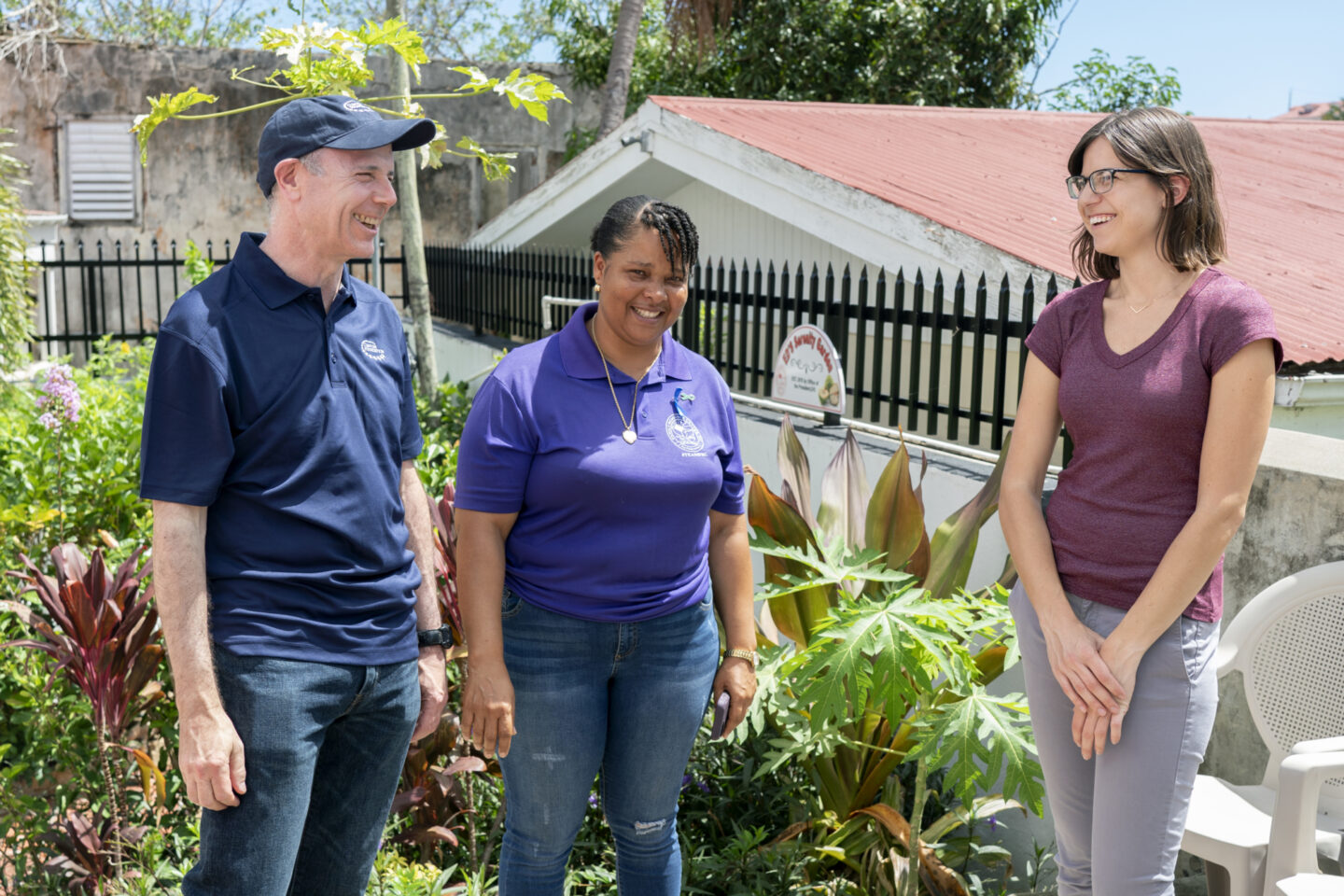 Clinton Foundation staff speak with an employee at a resource center in the U.S. Virgin Islands
