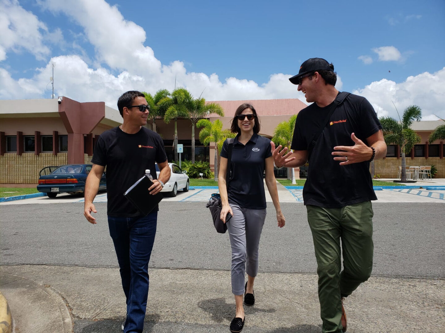 Clinton Foundation and Direct Relief staff members walk around a medical center in Puerto Rico