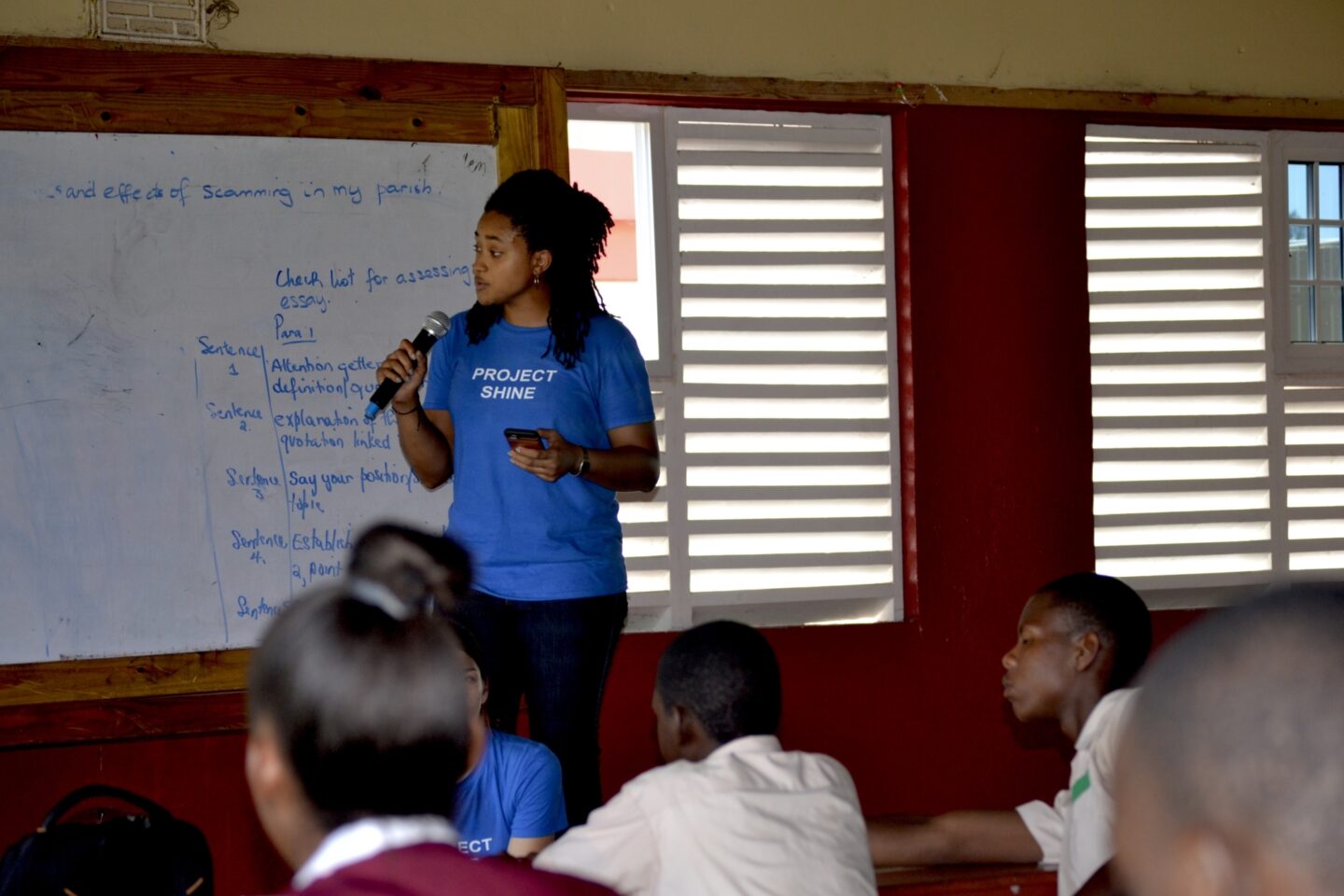 A Clinton Foundation employee teaches a lesson to students in Jamaica