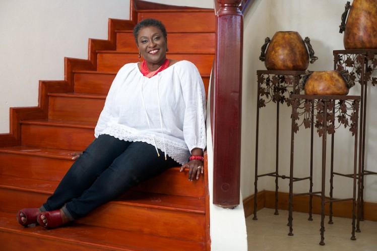 Portrait of Liz Thompson seated on set of stairs