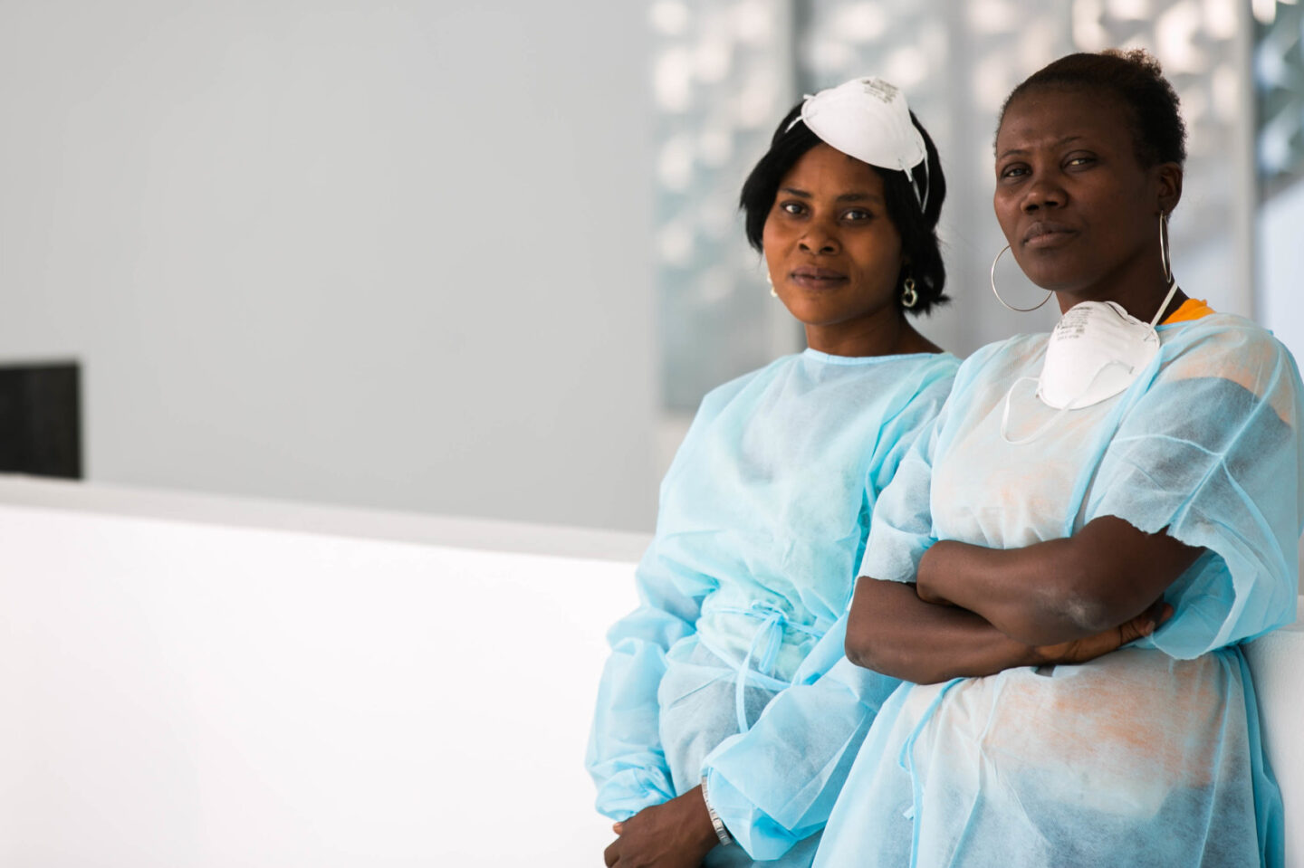 Two individuals wearing medical gear