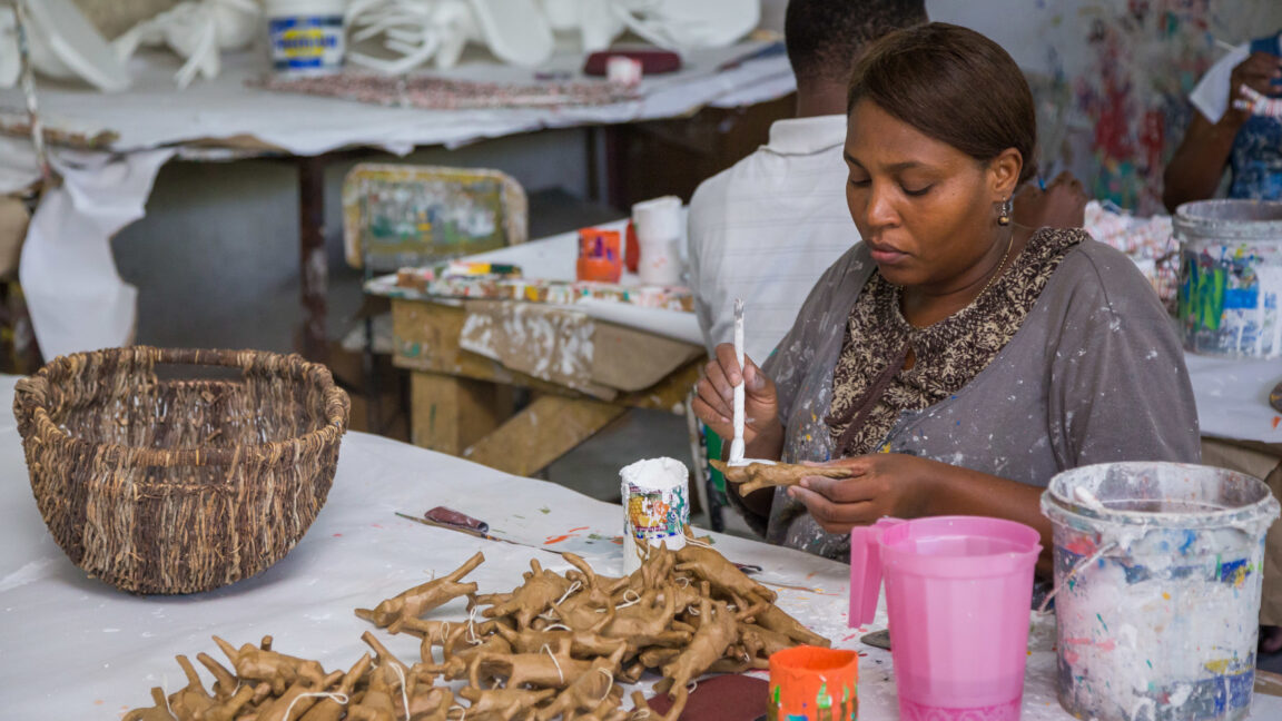 An individual paints artisanal pieces