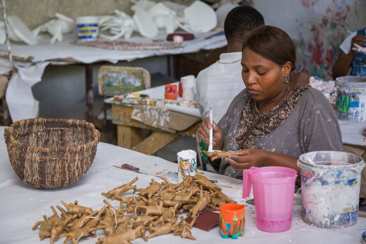 An individual paints artisanal pieces