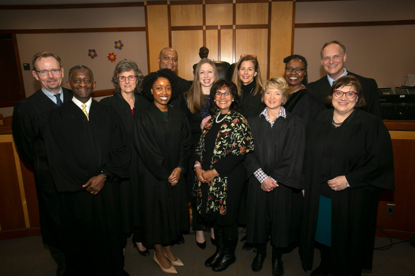 Chelsea Clinton with a group of judges. Most are wearing black robes.