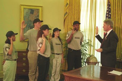 A group of Americorps volunteers stand in the Oval Office raising their right hands