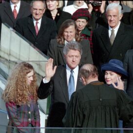 President Clinton raises his right hand while taking the oath of office in front of the United States Capitol