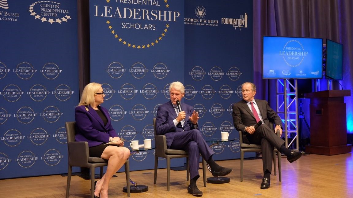 Stephanie Streett, President Clinton, and President George W. Bush seated onstage during a Presidential Leadership Scholars event