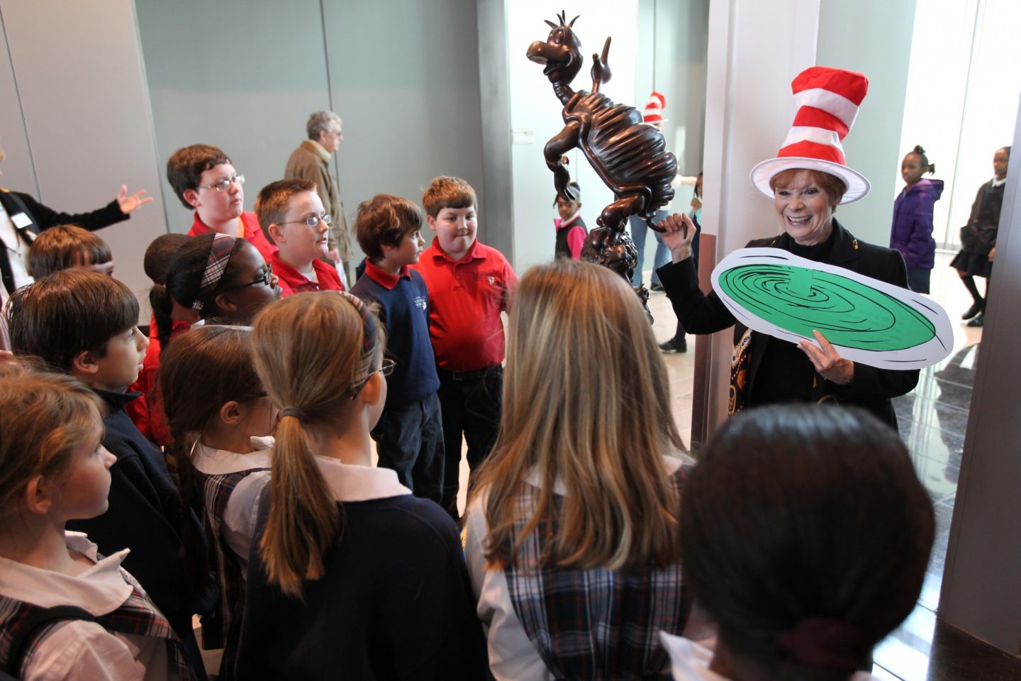 A Clinton Center volunteer leading a touring a students during Read Across America Week