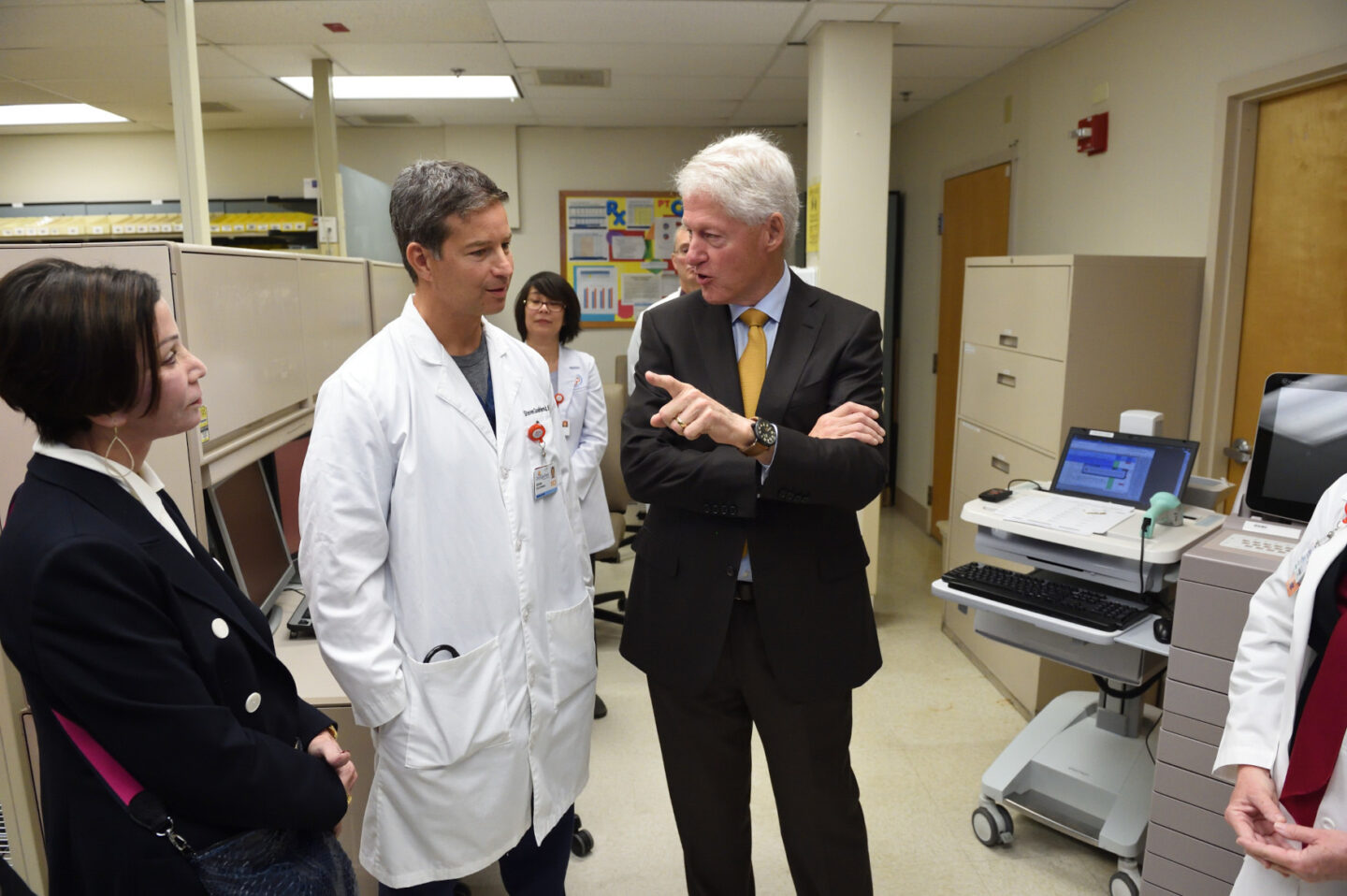 President Clinton speaks with a doctor inside a medical center