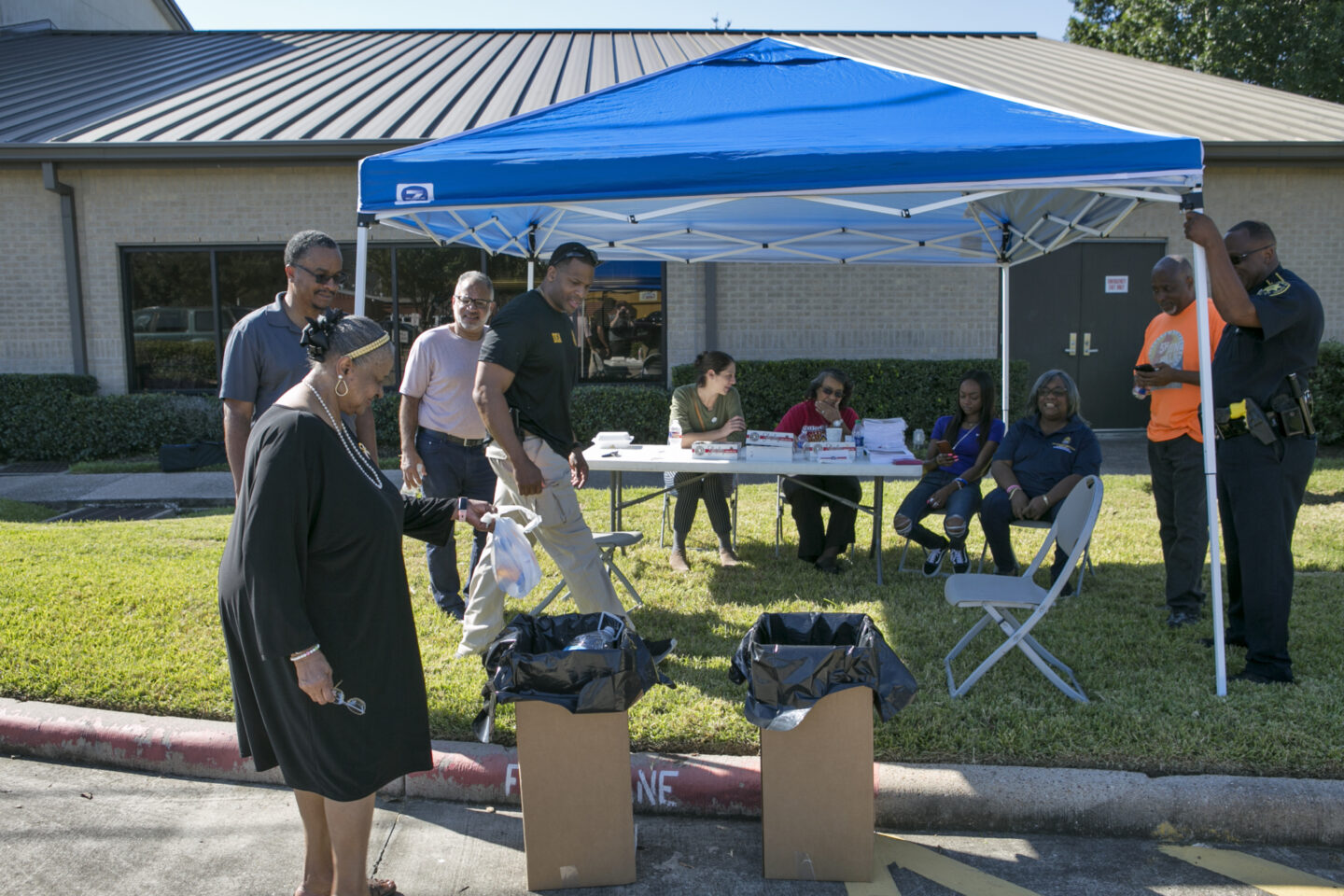 Individuals gather and dispose of medications at a Drug Takeback Day event