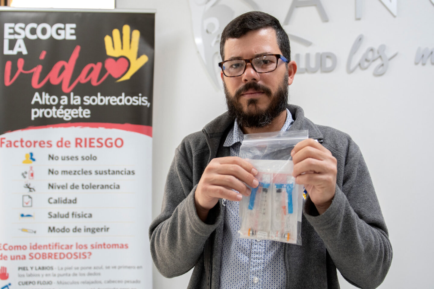 An individual holds a bag containing medical supplies