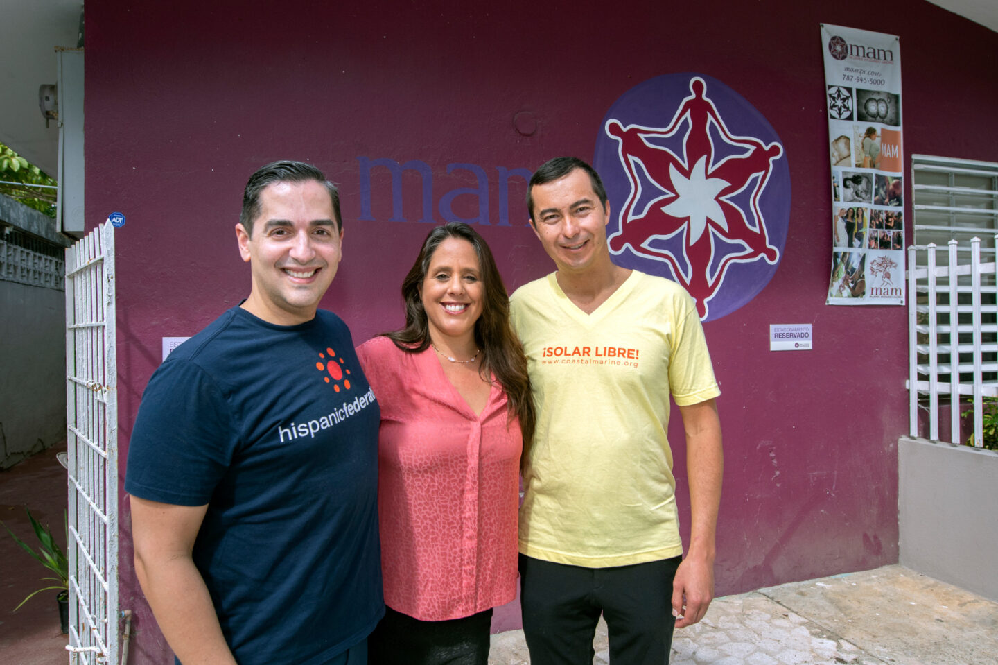 Vanessa Caldari, founder of Centro MAM, meets with representatives from the Hispanic Foundation and Solar Libre in front of the center in Puerto Rico
