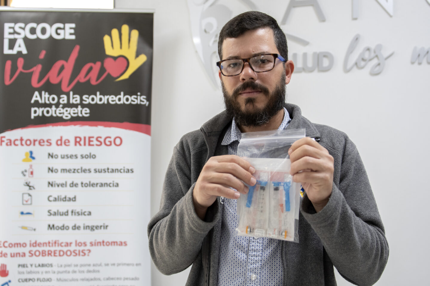 An individual holds a bag of medical supplies