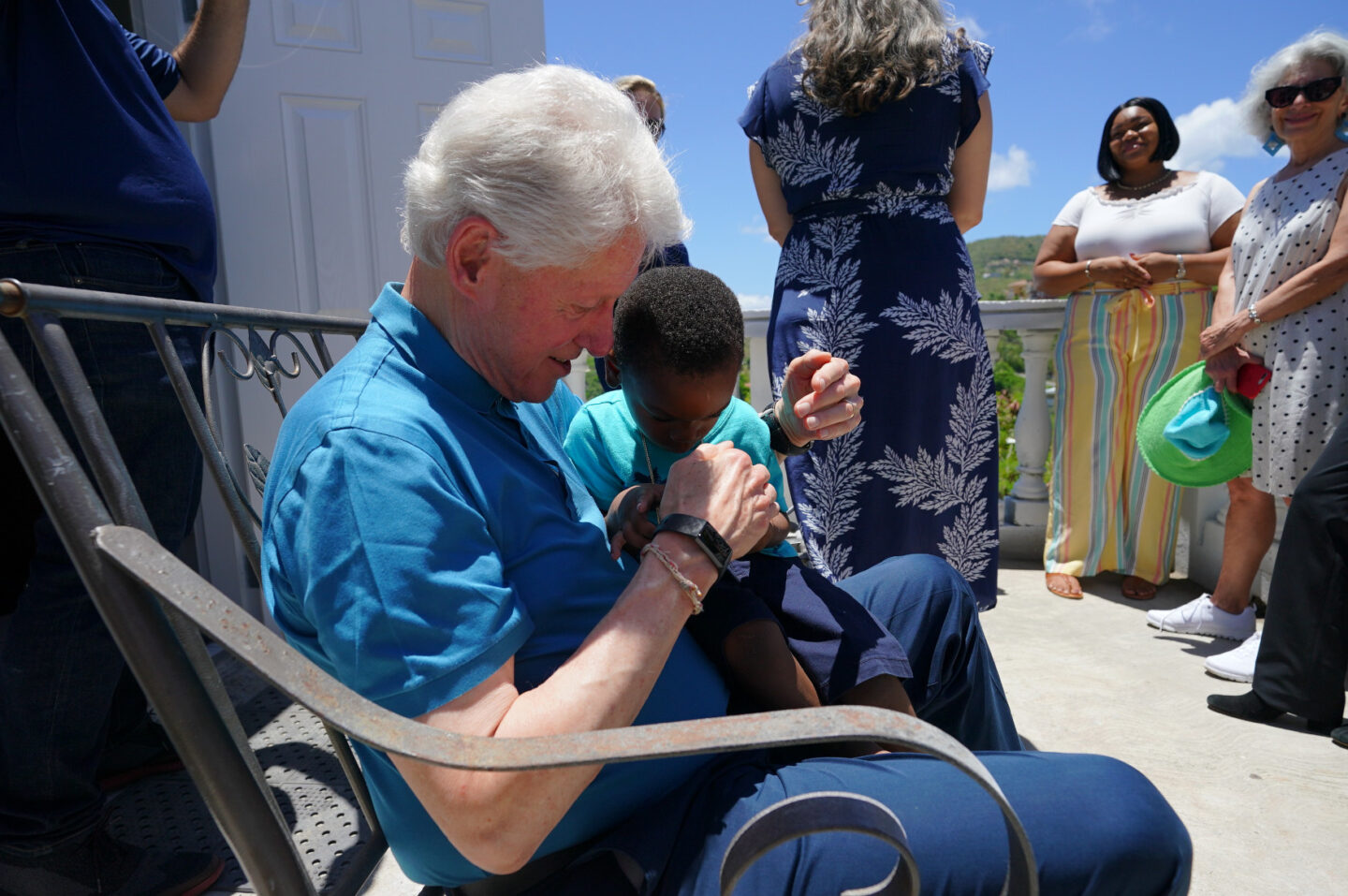 President Clinton plays a video game with a child in the U.S. Virgin Islands