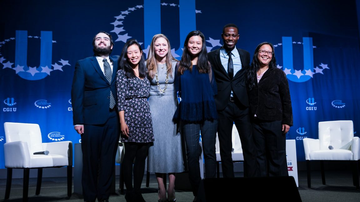 A group of students onstage with Chelsea Clinton during a CGI U event