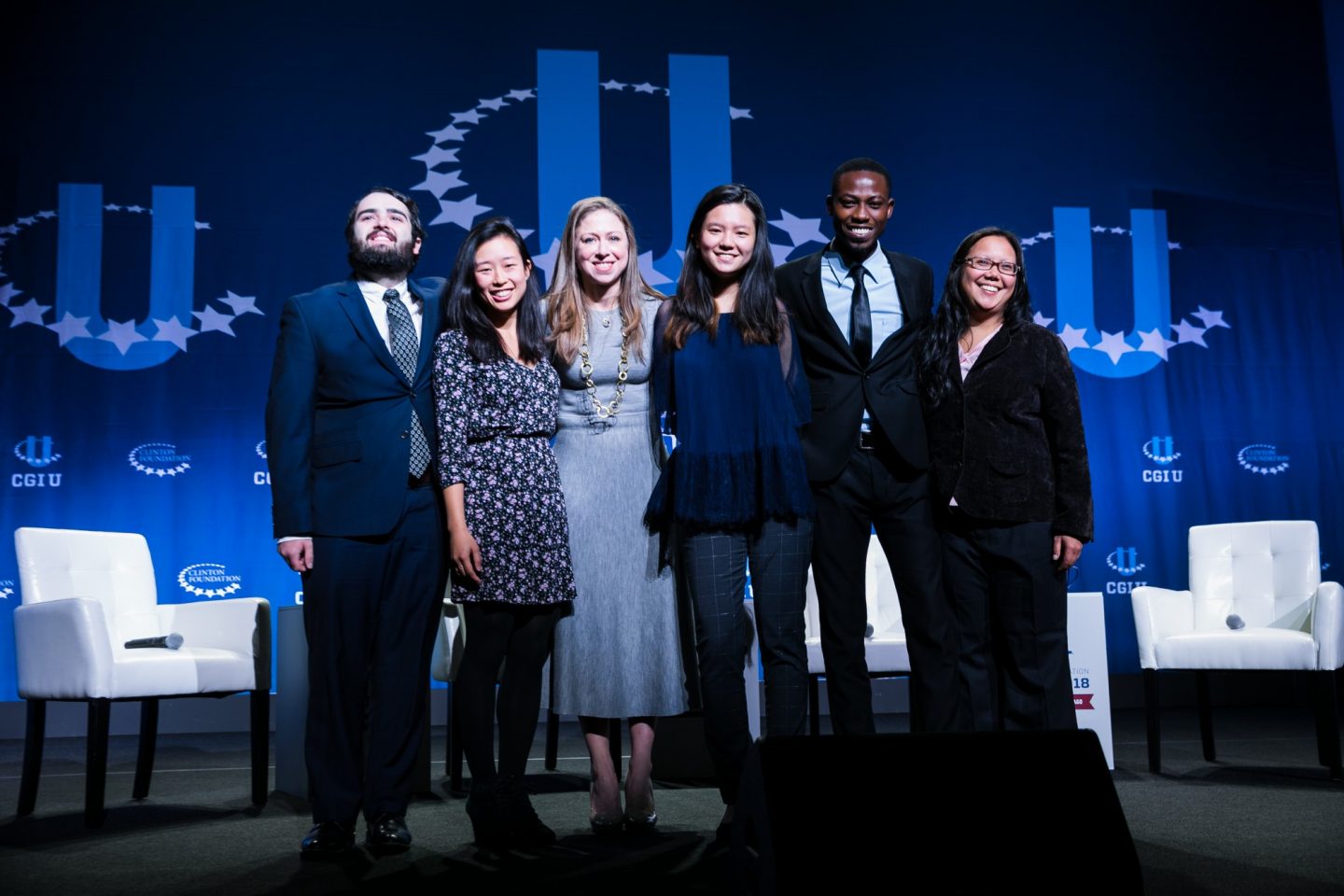 A group of students onstage with Chelsea Clinton during a CGI U event