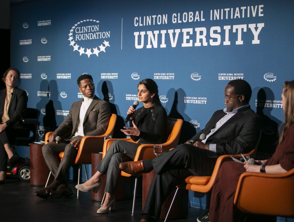 Individuals participate in a panel discussion during a CGI U event