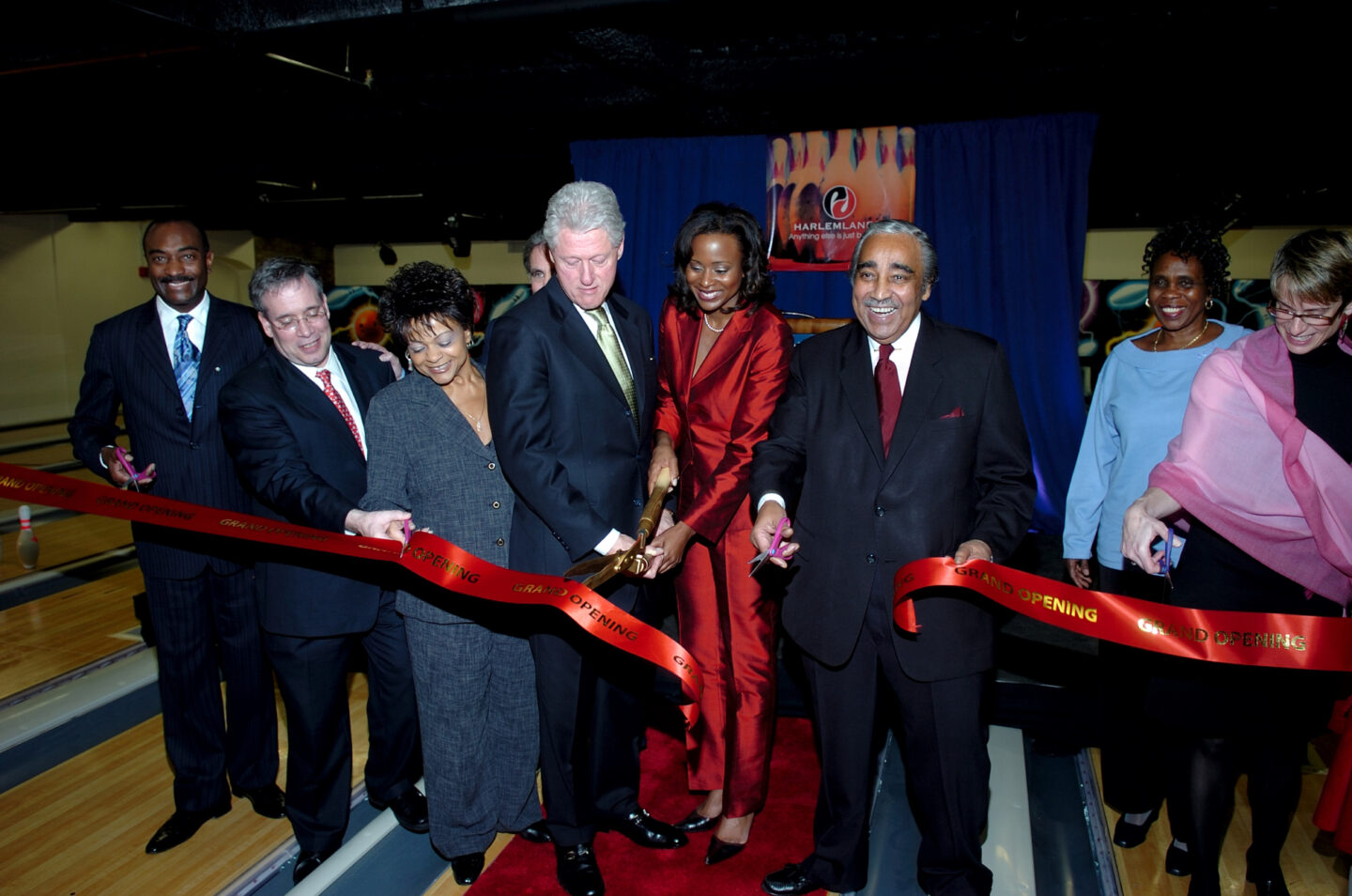 President Clinton, local leaders, and small business owners help open a bowling alley in Harlem, NY