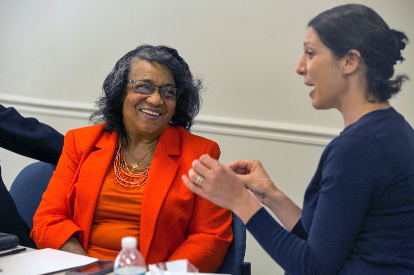Two individuals speak with one another