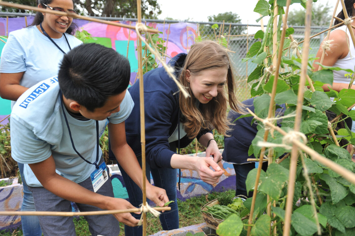 Chelsea Clinton and volunteers in a garden