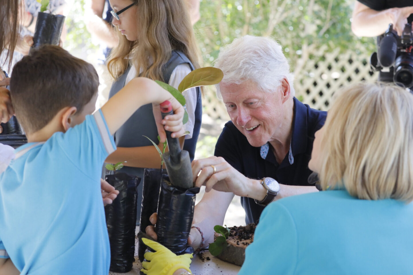 President Clinton and Secretary Clinton help plant tree saplings in Puerto Rico